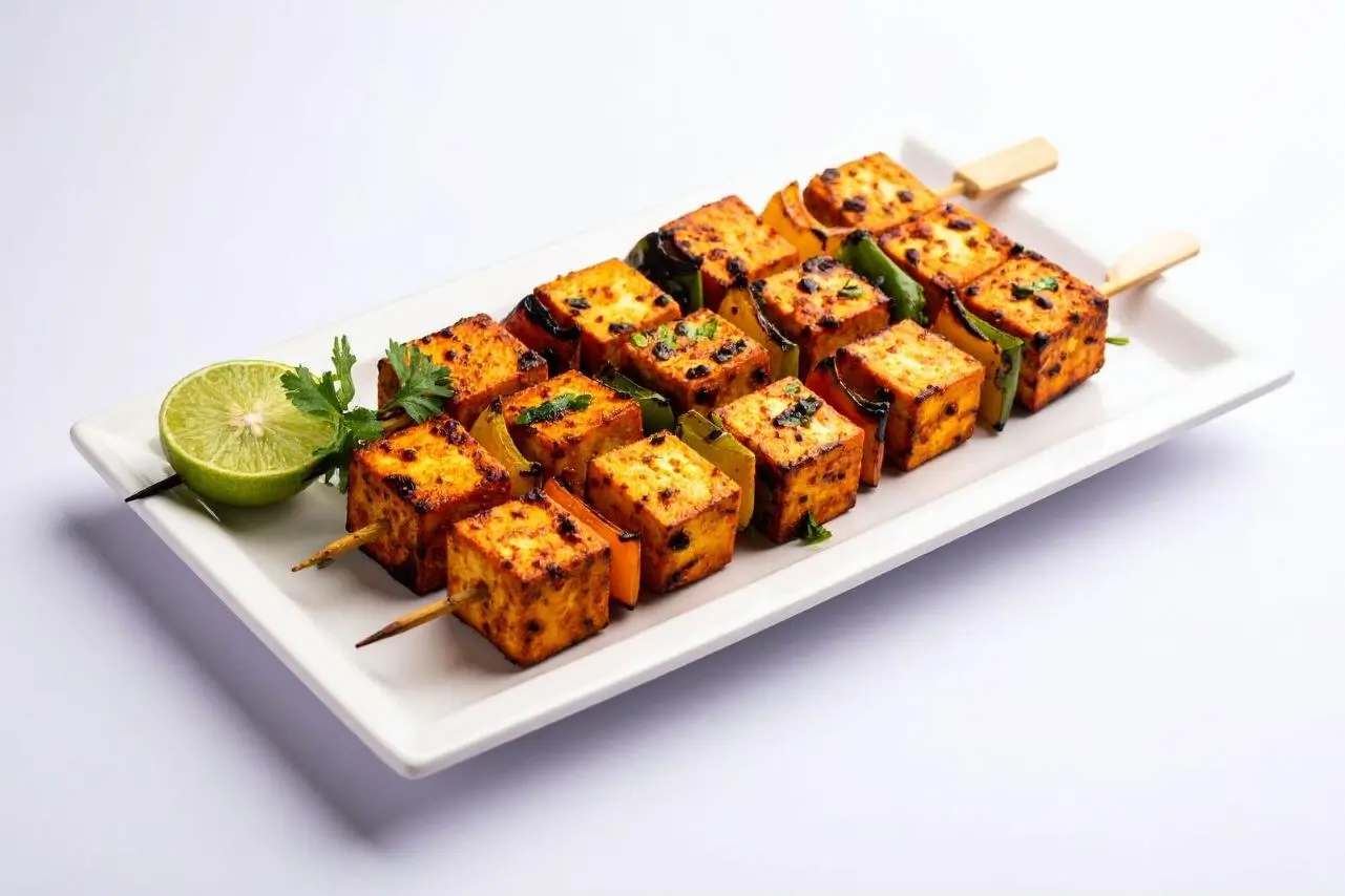 Spiced grilled tofu & vegetable skewers served with lime at Foodie BBQ & Bar, a Chinese Restaurant in New York
